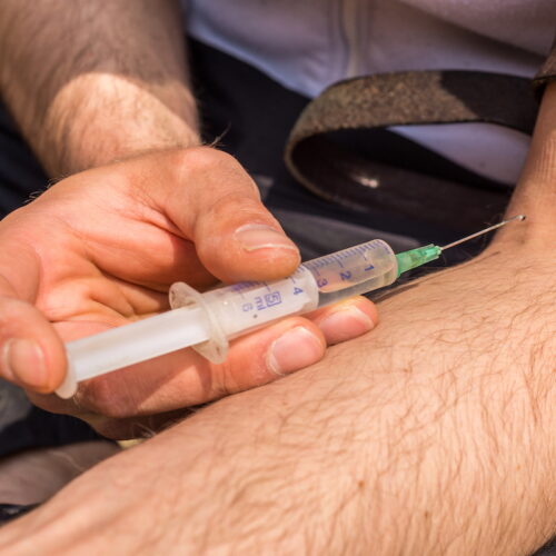 Drug addict injecting Sauare